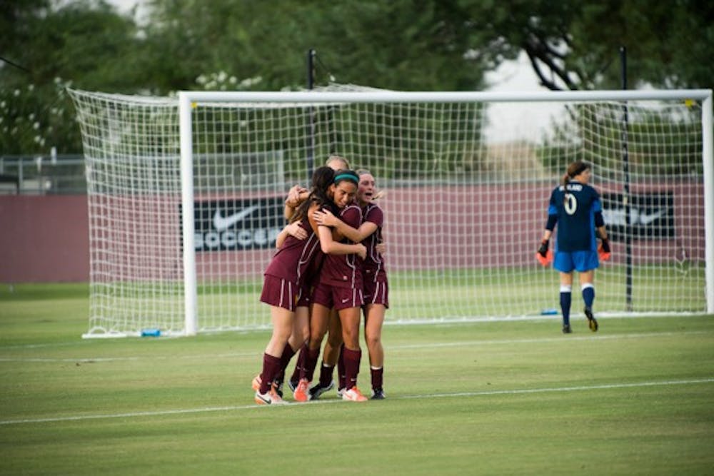 The ASU women's soccer team celebrates a point by Junior forward Cali Farquharson. (Photo by Andrew Ybanez)