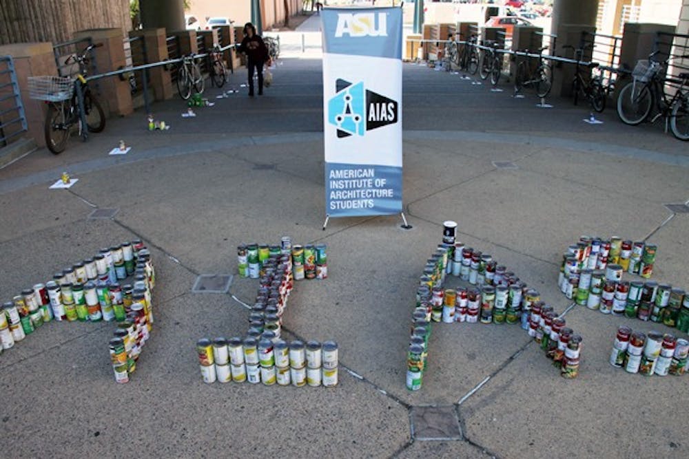 STACKING UP: Cans sit outside the Design school on Wednesday afternoon as part of The American Institute of Architecture Students canned food drive. (Photo by Rosie Gochnour)