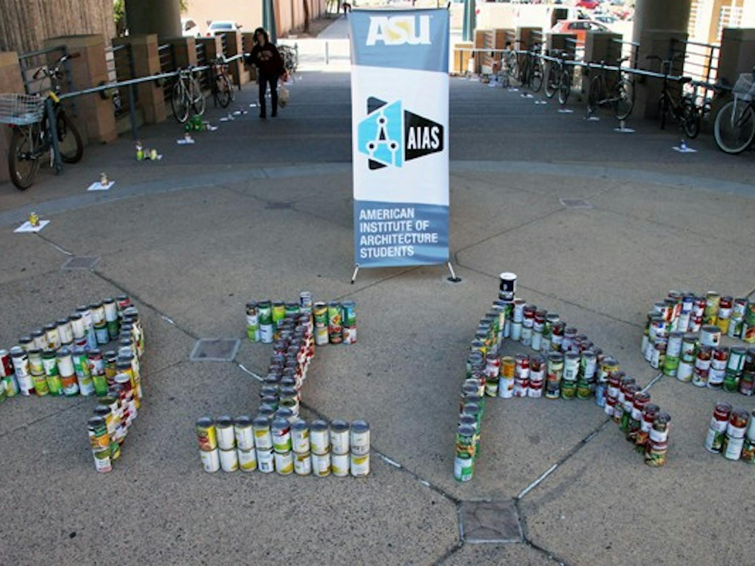 STACKING UP: Cans sit outside the Design school on Wednesday afternoon as part of The American Institute of Architecture Students canned food drive. (Photo by Rosie Gochnour)