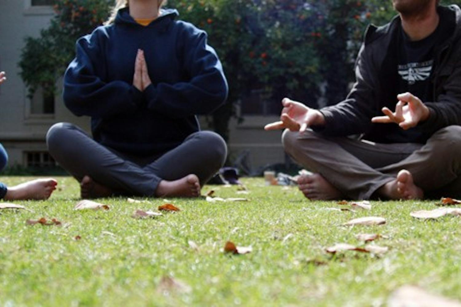 A few ASU students meditate in the secret garden to relieve themselves of stress. Starting Thursday, Quiet Your Mind and Focus meditation sessions will take place for an hour every week in the Discovery Hall to help students relieve stress in their daily lives. (Photo by Shelby Bernstein)