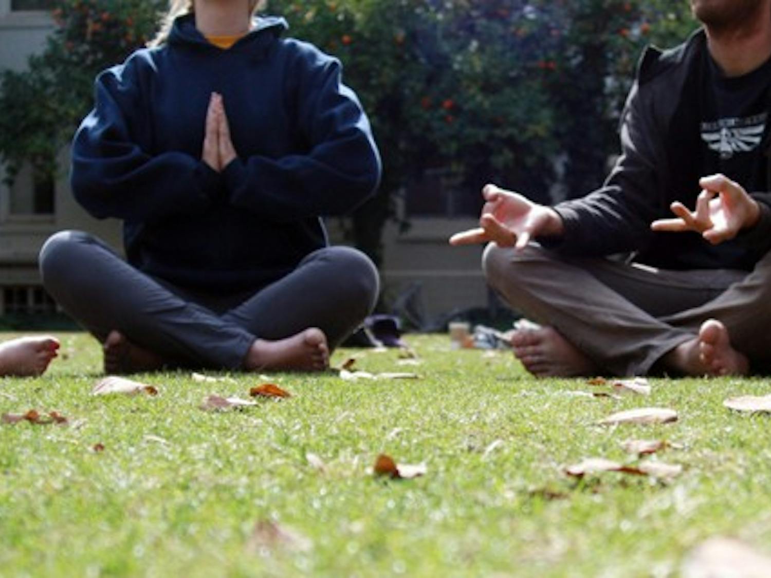 A few ASU students meditate in the secret garden to relieve themselves of stress. Starting Thursday, Quiet Your Mind and Focus meditation sessions will take place for an hour every week in the Discovery Hall to help students relieve stress in their daily lives. (Photo by Shelby Bernstein)
