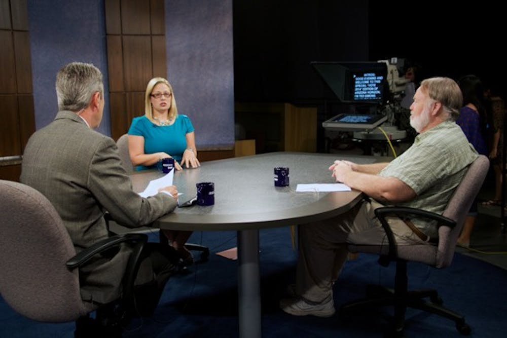 Arizona PBS mediator Ted Simons, center, conducts a debate between 9th district congressional candidates Powell Gammill, left, and Kyrsten Sinema, Oct. 20. (Photo by Andrew Ybanez)