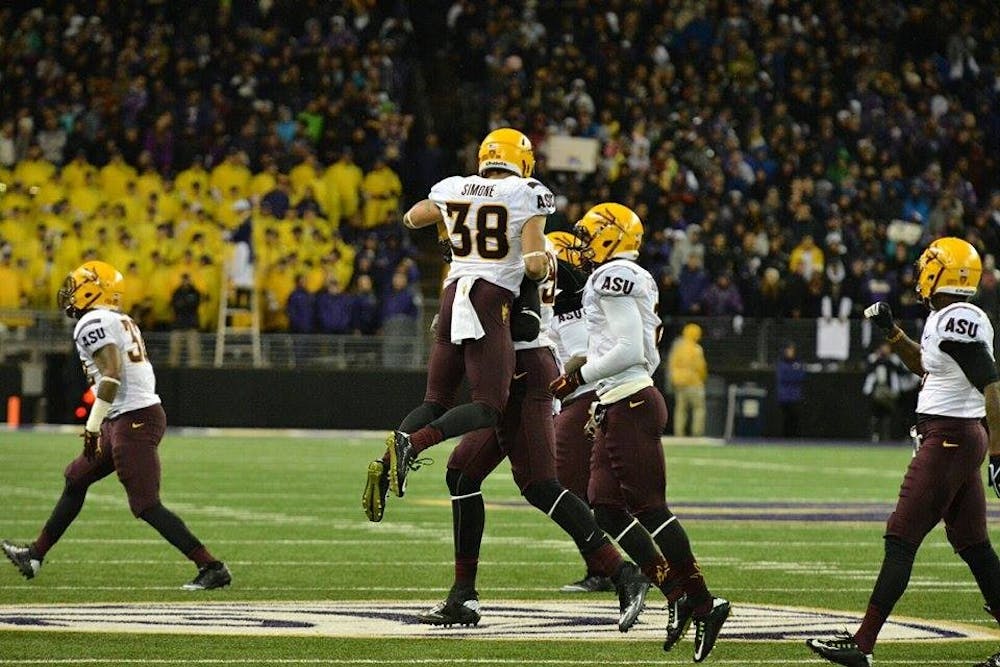 Redshirt junior safety Jordan Simone celebrates with his teammates after forcing a Washington three-and-out in the first half of the Sun Devils' game against the Huskies. ASU leads 10-0 at halftime. (Photo by Andrew Ybanez)