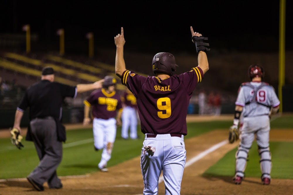 ASU junior infielder Christopher Beall motions after sophomore infielder Cody Woodmansee’s 2-run double in the 7th inning at the ASU vs. Oklahoma baseball game at Phoenix Municipal Stadium on Feb. 18, 2015. Woodmansee’s double was a part of the five-run explosion in the bottom of the 7th for the Sun Devils. (Daniel Kwon/The State Press)