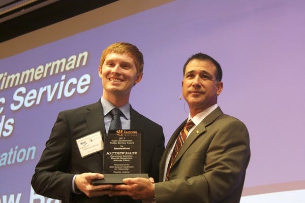 IN HONOR: Matthew Bauer, Procurement Supervisor for Materials Management of Maricopa County, is handed the Gabe Zimmerman Public Service Award for Innovation by President and CEO of Helios Education Foundation Paul Luna on Friday at the National Conference on Citizenship. (Photo by Shawn Raymundo)
