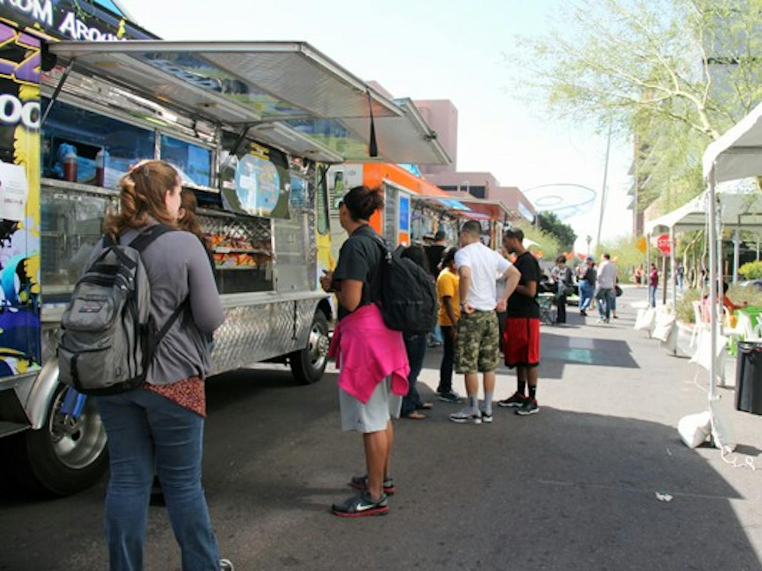 ASU students buy Mexican, barbecue and other types of food from food trucks on Taylor Street Monday afternoon. (Photo by Diana Lustig)
