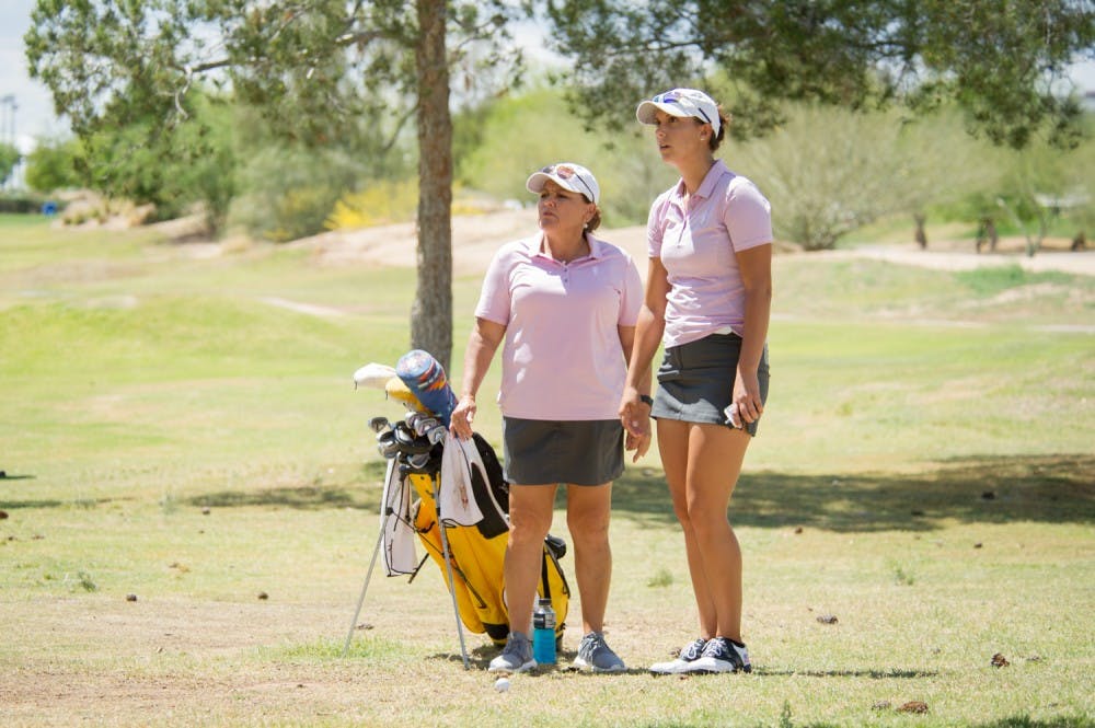Junior Monica Vaughn and head coach Missy Farr-Kaye discuss the way to best approach the ball on fairway five on Friday, April 8, 2016 during the 2016 Ping ASU Invitational at Karsten Golf Course in Tempe, Arizona.