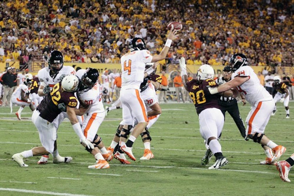 CONTROL PROBLEMS: OSU redshirt freshman Sean Mannion throws a pass downfield while the line holds back the ASU defense during the Beavers’ 35-20 loss to the Sun Devils on Saturday. Oregon State is 0-4 so far during their season. (Photo by Beth Easterbrook)
