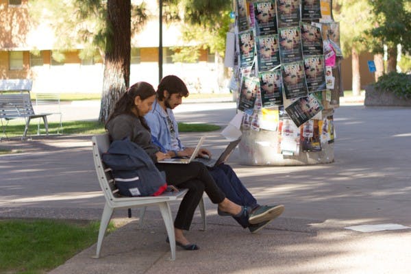 Graduate students Tanvi Apte and Siddhanth Paralkar studying near the Memorial Union before class on Nov. 25, 2014. Sites like paymetodoyourhomework.com offer to complete homework and tests for students for a charge. (Photo by Emily Johnson)
