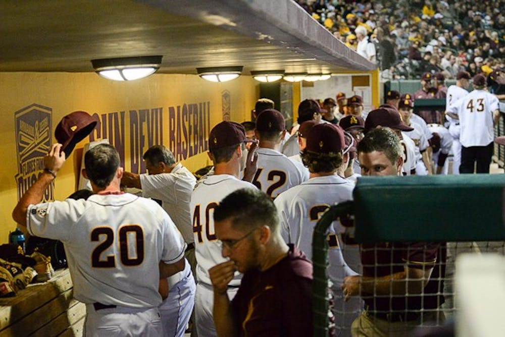At the end of the first inning, the Sun Devils return to the dugout at the end of the first inning of a game against Oklahoma State on Friday, Feb. 13, 2015 at Phoenix Municipal Stadium. (J. Bauer-Leffler/The State Press)