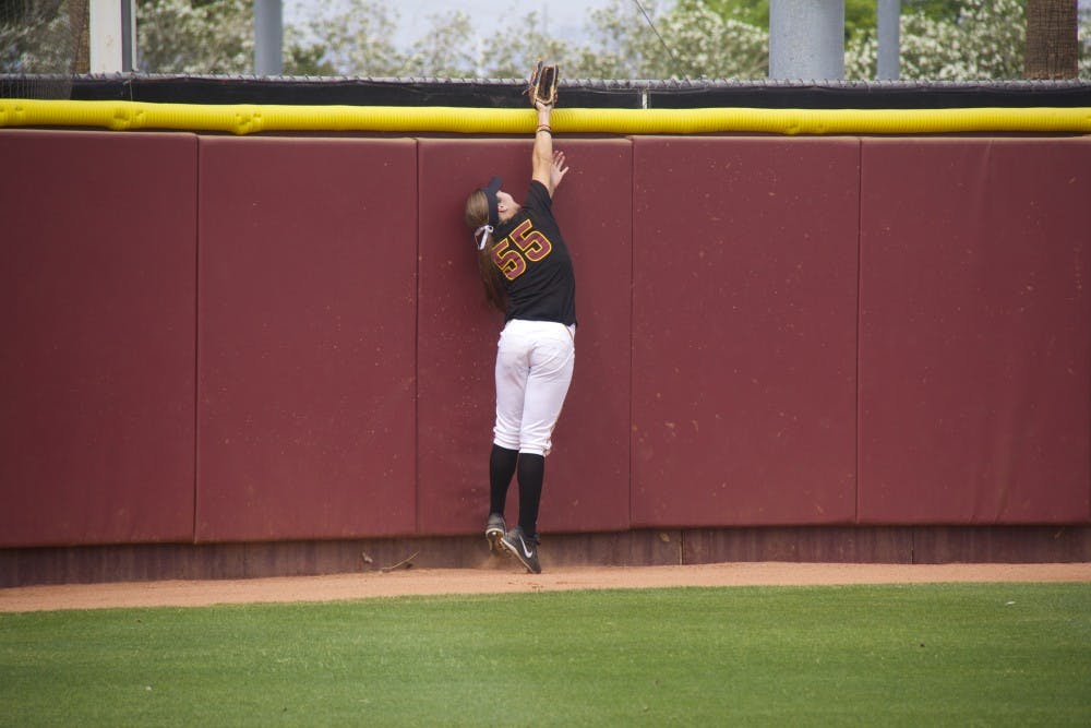 Then- Junior outfielder Elizabeth Caporuscio jumps for a ball that flies over the fence, giving the Michigan Wolverines a home run during game one of the NCAA Tempe Regional Championships on Sunday, May 18, at Farrington Stadium. ASU lost to Michigan 3-4. (Photo by Becca Smouse)