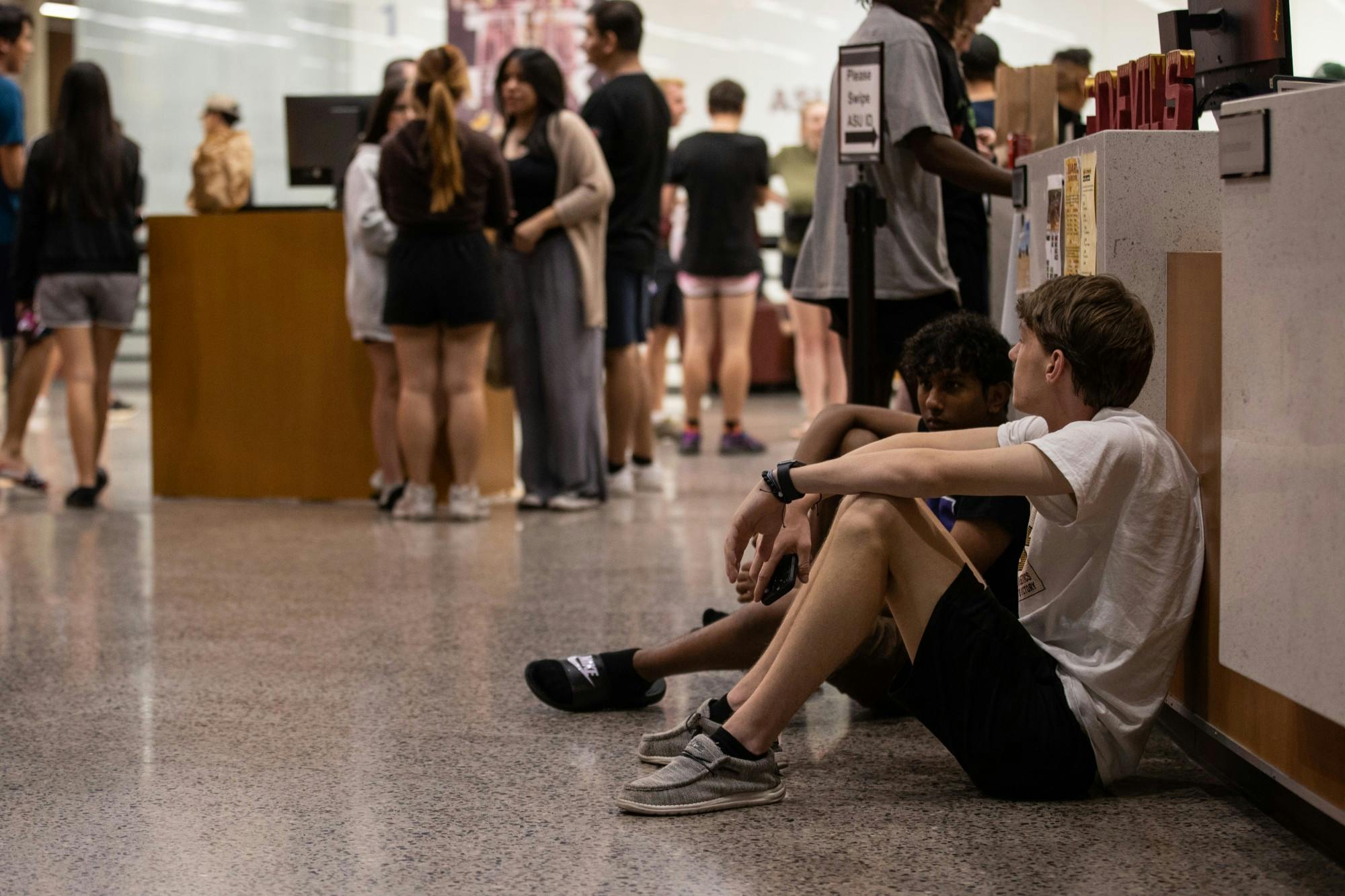 Evacuated students wait at SDFC