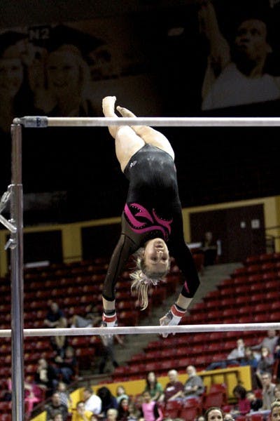 Senior Amelia Rew focuses on the bar in front of her as she about to make her transition on Jan. 25 against UCLA. The ASU gymnastics team lost focus on the beam and suffered a loss to rival UA on March 2. (Photo by Sam Rosenbaum)