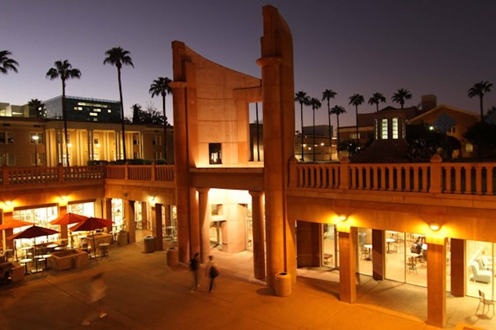 STUDY GLOW: Hayden Library's "Beacon of Knowledge" glows at dusk Tuesday, Oct. 11 as students enter the library to do their nighttime studying. (Photo by Lisa Bartoli)