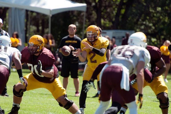Redshirt junior quarterback Mike Bercovici takes the snap during a play at a scrimmage on Aug. 16. (Photo by Mario Mendez)
