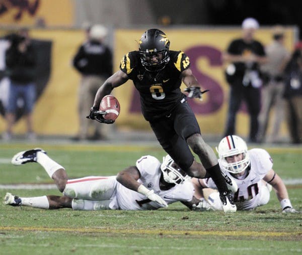 Gerell Robinson breaks a tackle during the Territorial Cup on Nov. 19. Robinson accepted an invitation to play in the East-West Shrine Game in St. Petersburg, Fla. (Photo by Beth Easterbrook)