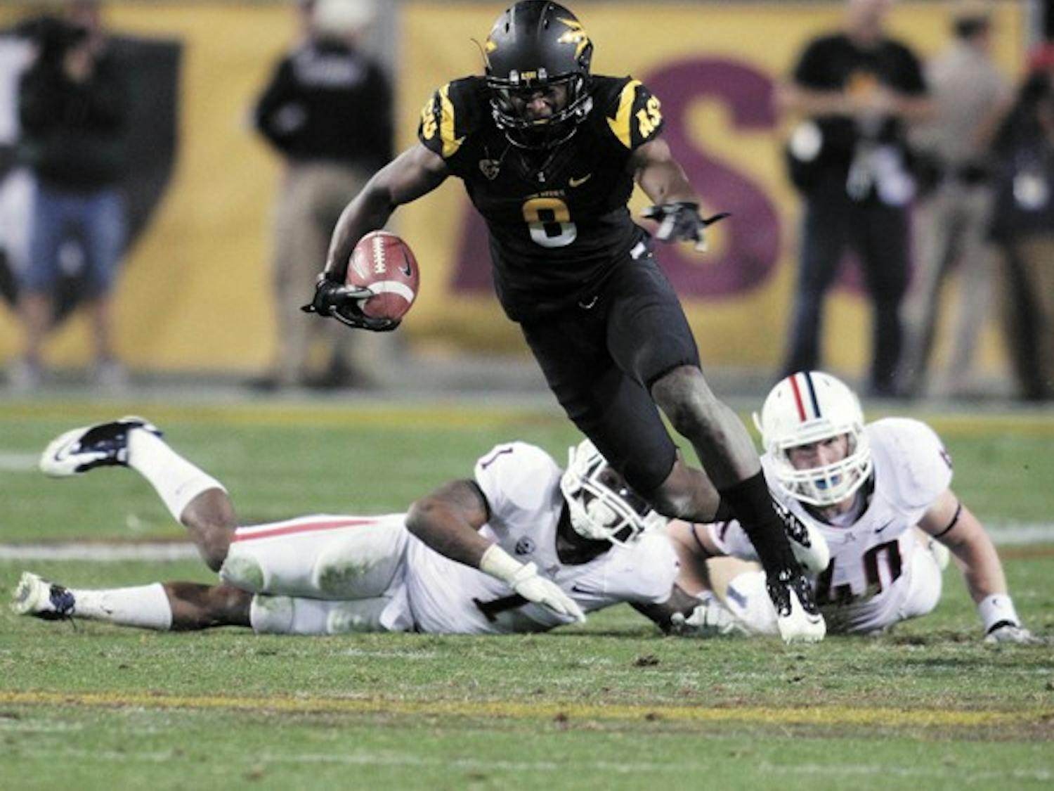 Gerell Robinson breaks a tackle during the Territorial Cup on Nov. 19. Robinson accepted an invitation to play in the East-West Shrine Game in St. Petersburg, Fla. (Photo by Beth Easterbrook)