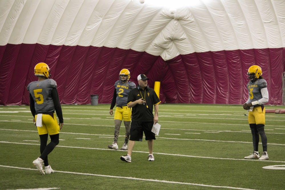 (From left) Manny Wilkins, Brady White, and Bryce Perkins work with quarterbacks coach, Chip Lindsey (center) during Friday's practice. 8 April 2016