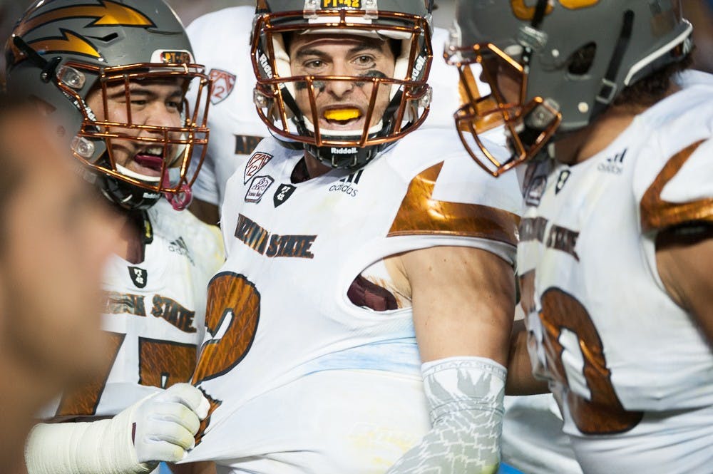 Redshirt senior quarterback Mike Bercovici (2) celebrates with his team after scoring a rushing touchdown against UCLA on Saturday, Oct. 3, 2015, at Rose Bowl Stadium in Pasadena, Calif. The Sun Devils defeated the Bruins 38-23.