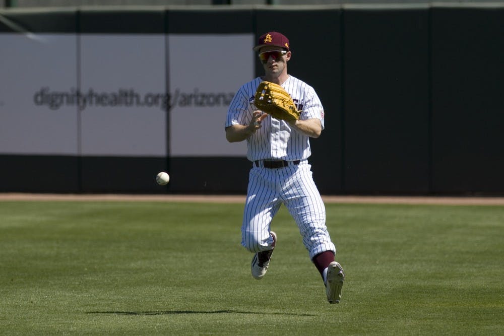 ASU sophomore outfielder Gage Canning (12) picks up a ball after it landed in front of him during game three of a baseball series against the Oregon State Beavers at Phoenix Municipal Stadium in Phoenix on Saturday, March 18, 2017. ASU lost 4-0.