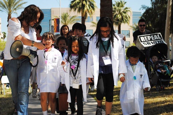 A future doctor led the march with Cassandra Belson, and yelled, “What do we want?” into the loudspeaker. The marchers responded, “Freedom.” (Photo by Yvonne Gonzalez)