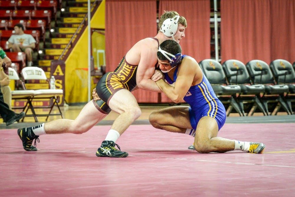 ASU freshman Jacen Petersen starts out strong against CSU Bakersfield's Adam Fierro. Petersen went on to win the match handily on Jan. 18, 2015, at Wells Fargo Arena in Tempe. The Sun Devils went on to win against the Roadrunners 31 – 6.&nbsp;