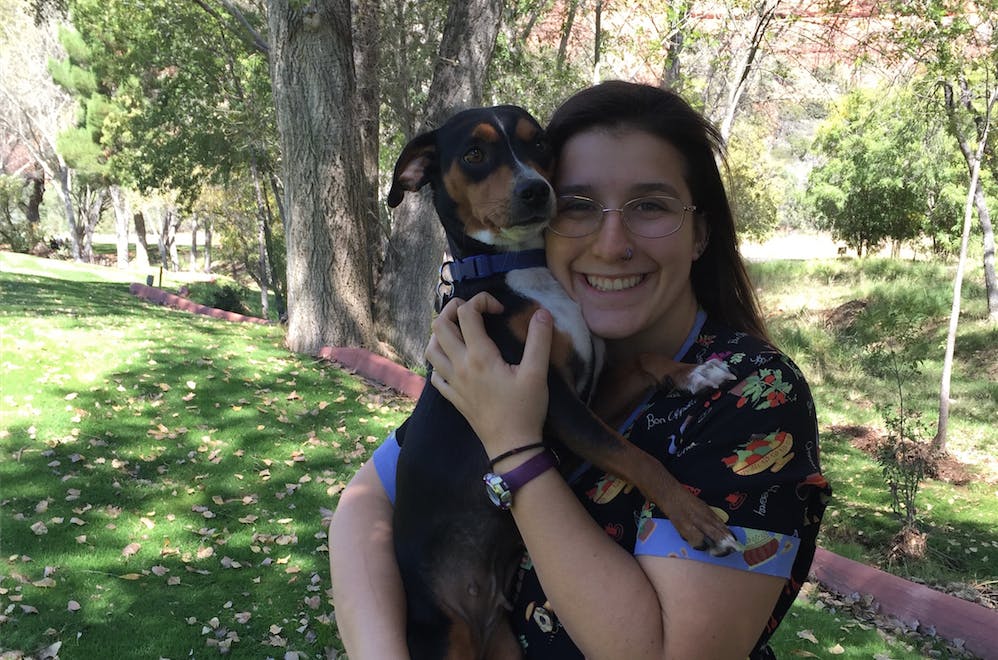 Emma Hobbs poses for a photo with her trained service dog,&nbsp;Bernie.