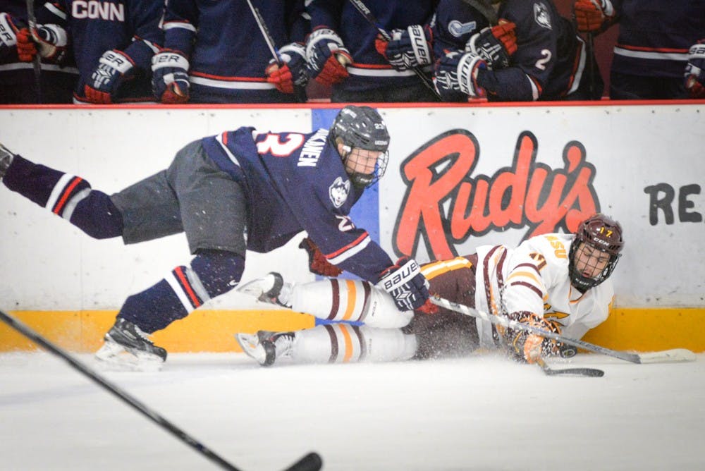 Freshman forward Jordan Masters falls to the ice to protect the ASU possession against UConnTuesday, January 5, 2016 at the Oceanside Ice Arena in Tempe, AZ.