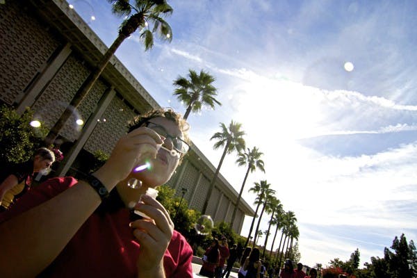 Interdisciplinary Studies junior Brendan Pantilione blows bubbles on Hayden Lawn during World AIDS day on Dec. 1. (Photo by Sam Rosenbaum)