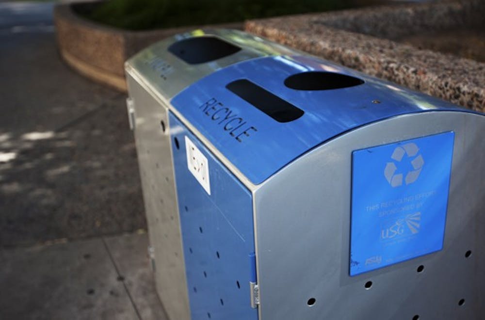 For two months, ASU registered an average recycling rate of 25 percent a week. These recycling bins are seen throughout the campus attached to a garbage can. (Photo by Perla Farais)