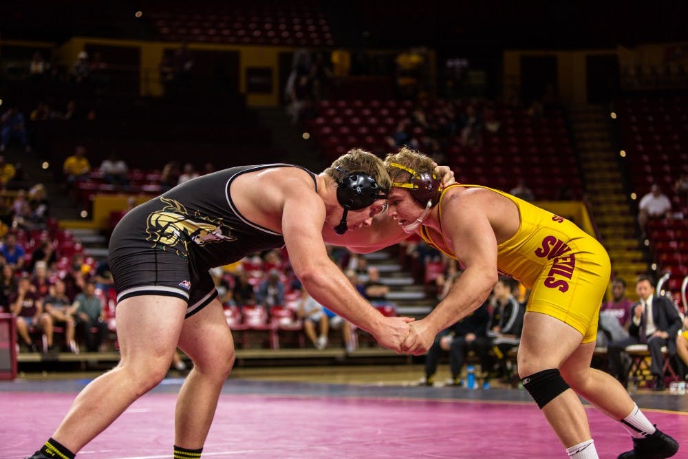 ASU redshirt senior wrestler Chace Eskam faces off against Cal Poly sophomore Nicolas Johnson in the 285-pound weight division match at Wells Fargo Arena on Feb. 16, 2015. The Sun Devils would roll to a 30-9 victory over the Mustangs. (Daniel Kwon/The State Press)