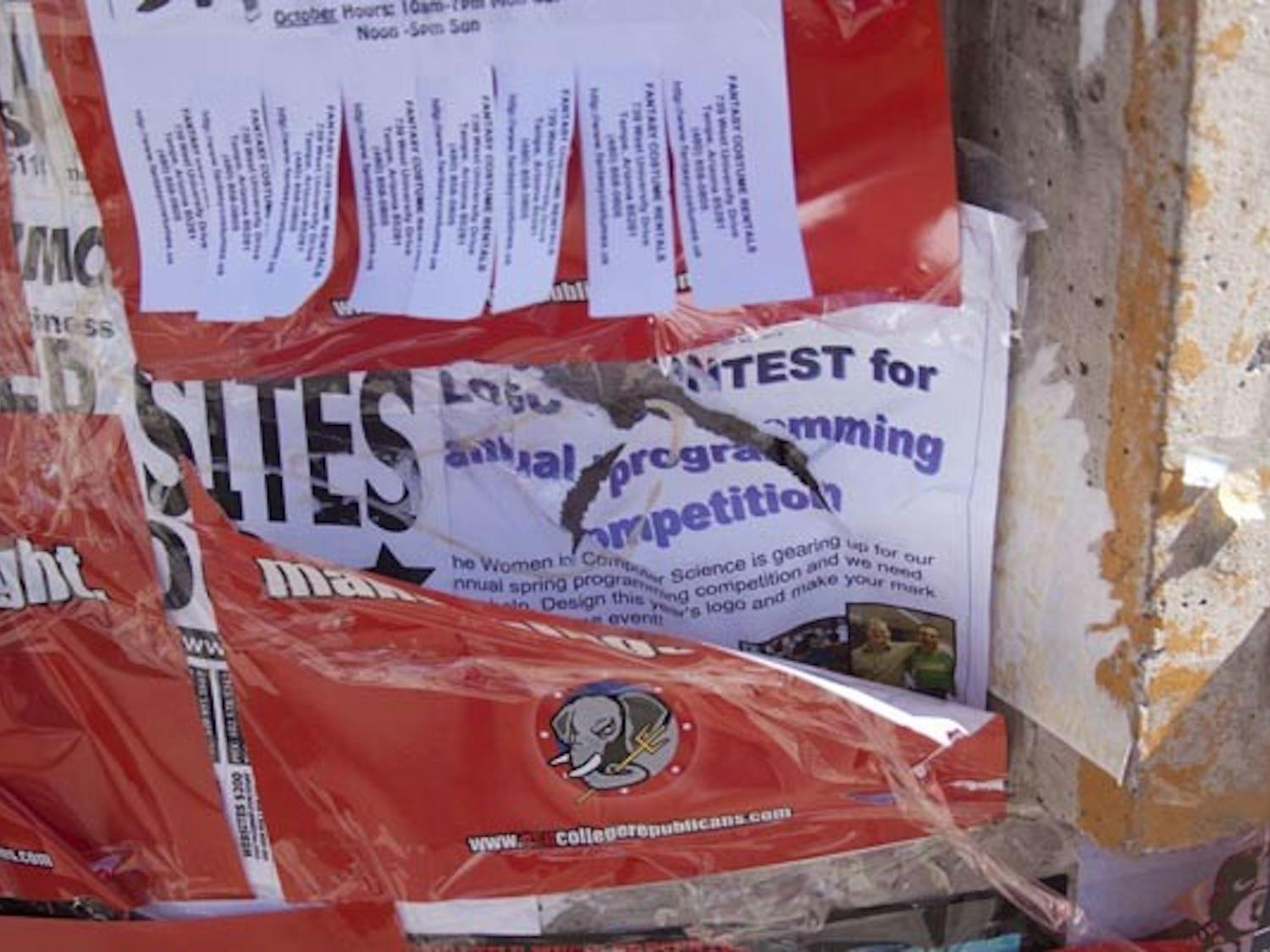 HIGH-DEMAND REAL ESTATE: ASU groups have witnessed other students ripping down posters and signs from the kiosks around campus. (Photo by Annie Wechter)