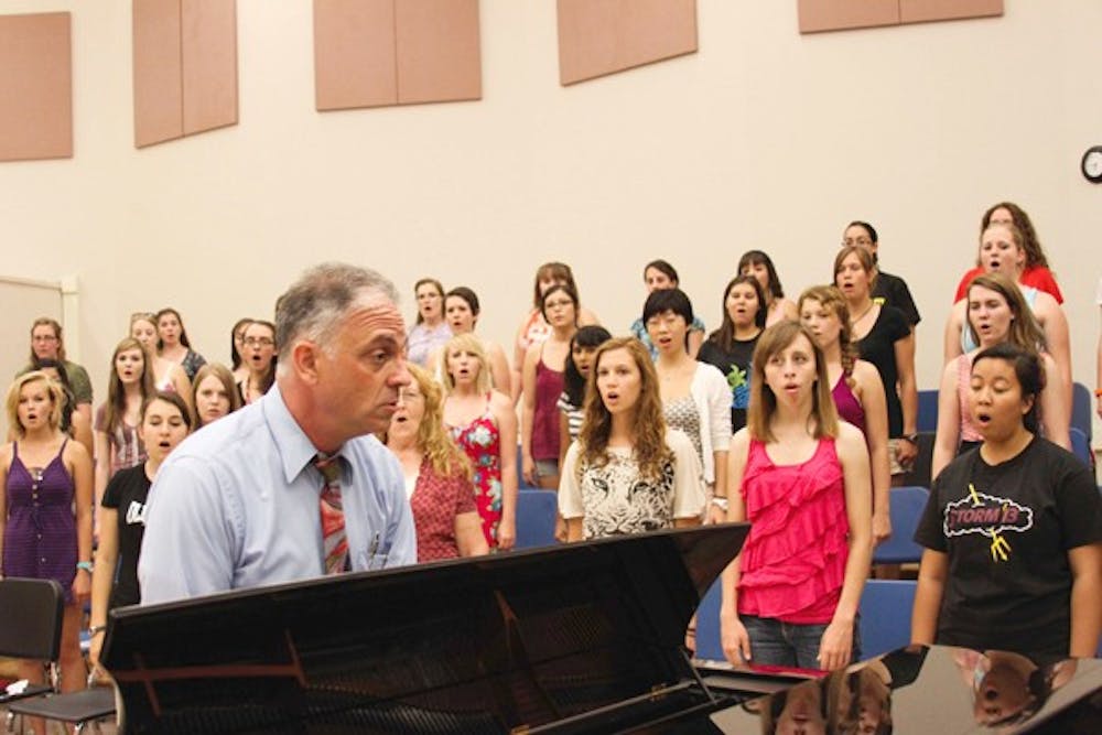 SING IT OUT: Students in the Barrett Honors College choir rehearsed for the first time Monday evening in the Gammage Auditorium, led by David Schildkret. (Photo by Lisa Bartoli)
