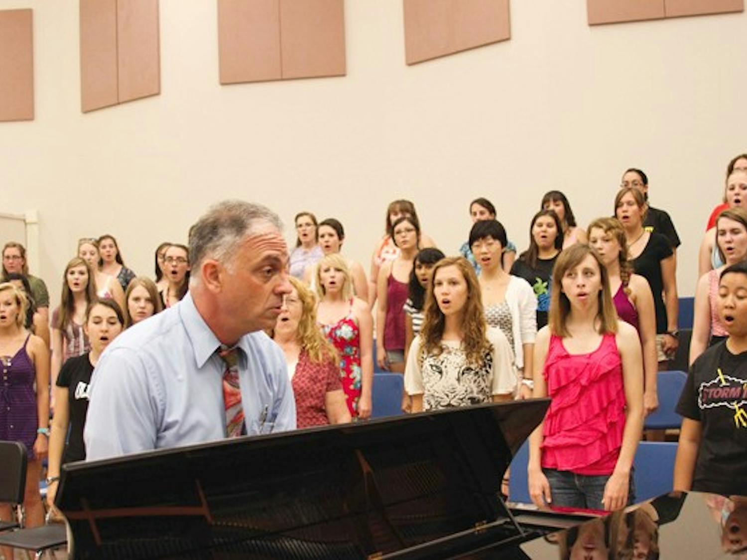 SING IT OUT: Students in the Barrett Honors College choir rehearsed for the first time Monday evening in the Gammage Auditorium, led by David Schildkret. (Photo by Lisa Bartoli)