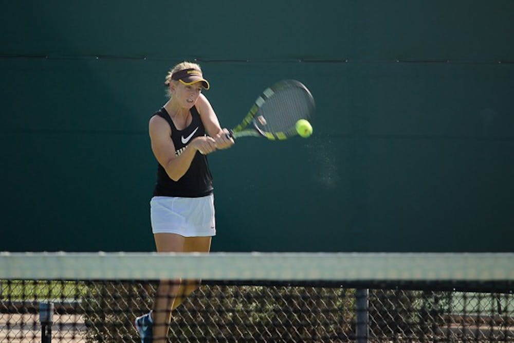 Senior Joanna Smith returns with a backhand against BYU’s Toby Miclat, Saturday, Feb. 14. Smith contributed a 1-6, 7-6, 7-5 win to the Sun Devils' 4-3 victory over the Cougars. (Shiva Balasubramanian/The State Press)