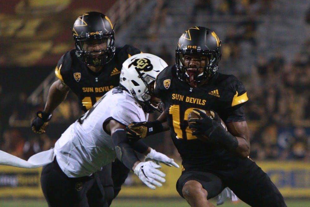 Redshirt junior wide receiver Tim White (12) breaks a tackle after catching a pass in the first quarter against Colorado on Saturday, Oct. 10, 2015, at Sun Devil Stadium in Tempe.