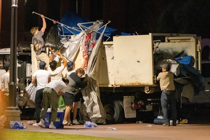 Counter-protesters and cleanup crews throw away camp equipment while pro-Palestine protesters occupy the Alumni Lawn outside of Old Main in an encampment called the "ASU Liberated Zone" on Friday, April 26, 2024, in Tempe.