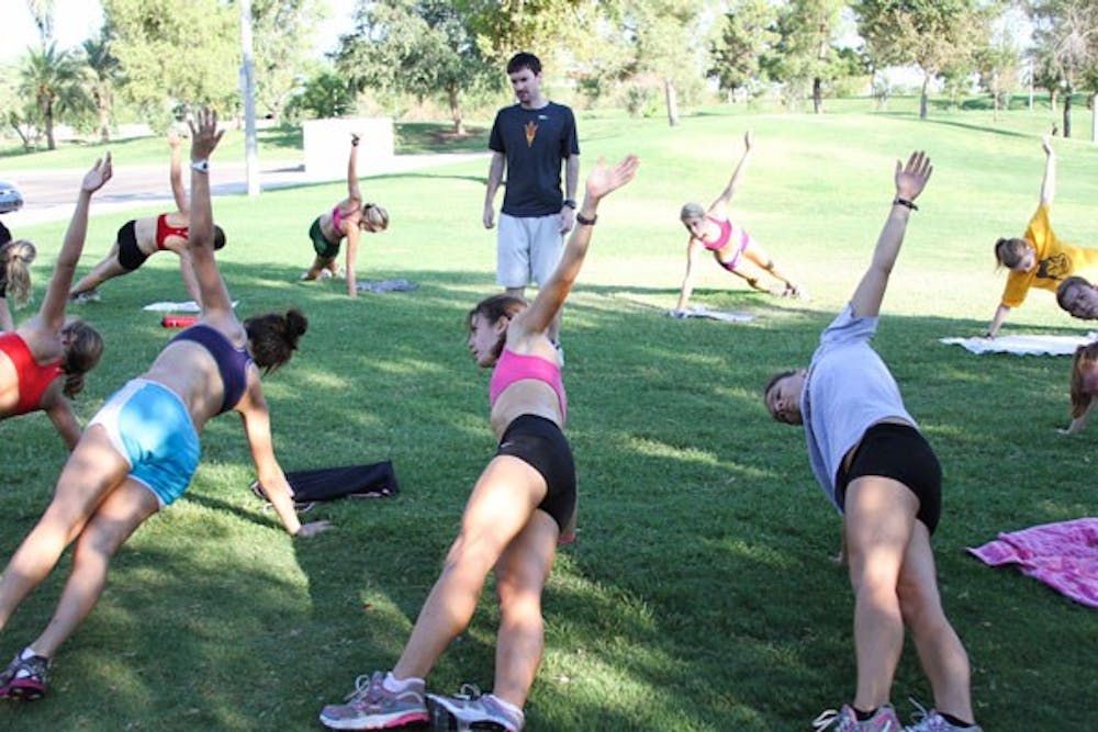 Women’s cross-country coach Ryan Cole observes his athletes stretching during a practice last year. ASU men and women’s cross-country teams begin their season in NAU’s George Kyte Invitational in Flagstaff on Saturday. (Photo by Lisa Bartoli)