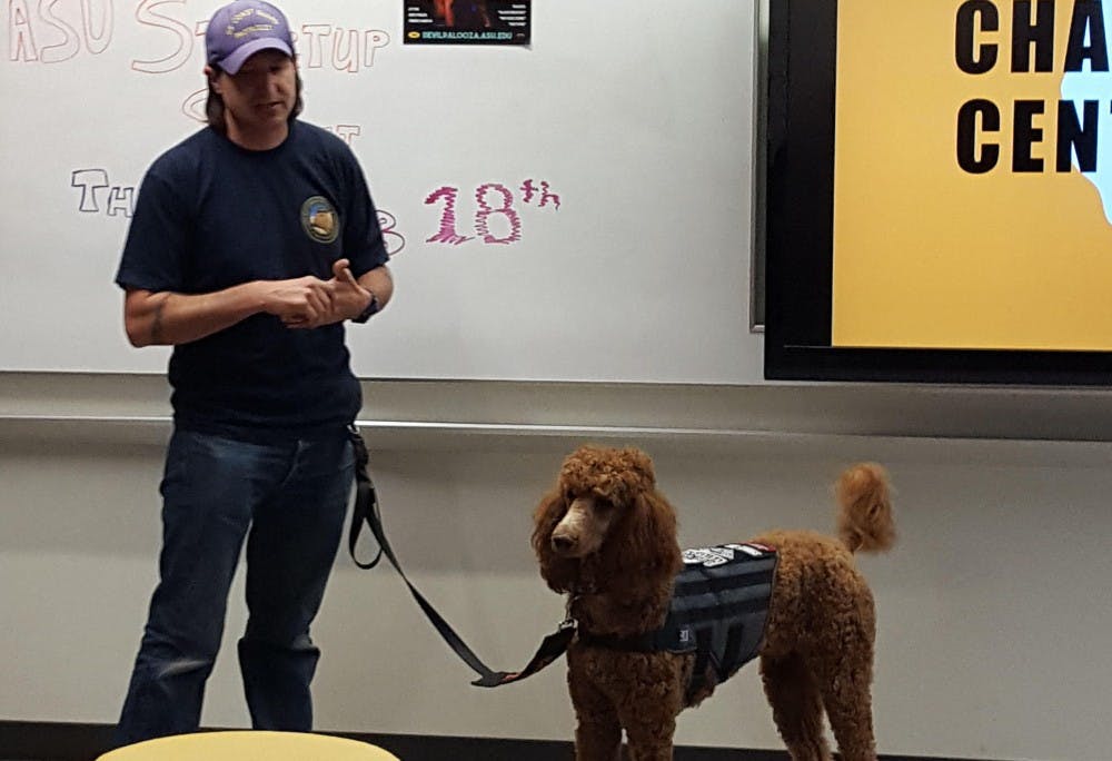 Scott Sefranka, a community advisor, and his service dog, Bigby Wolf, talk about service dogs at the Salute to Service event hosted by Engaging Minds on Feb. 18, 2017 on ASU's West campus.