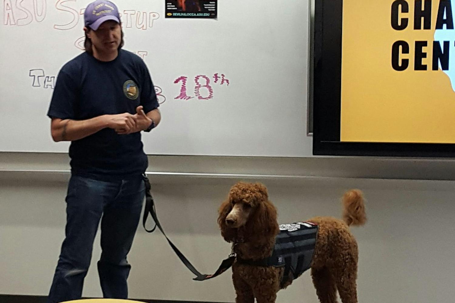 Scott Sefranka, a community advisor, and his service dog, Bigby Wolf, talk about service dogs at the Salute to Service event hosted by Engaging Minds on Feb. 18, 2017 on ASU's West campus.