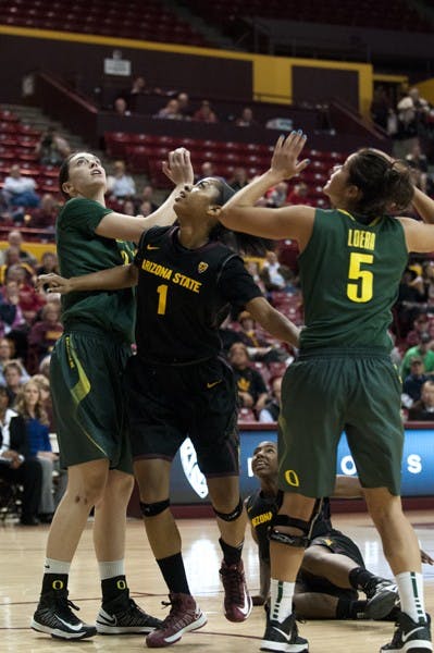 Freshman guard Arnecia Hawkins tracks a rebound against Oregon's junior forward Danielle Love (left) and Jordan Loera (right) during ASU's win against Oregon on Friday. (Photo by Molly J Smith)