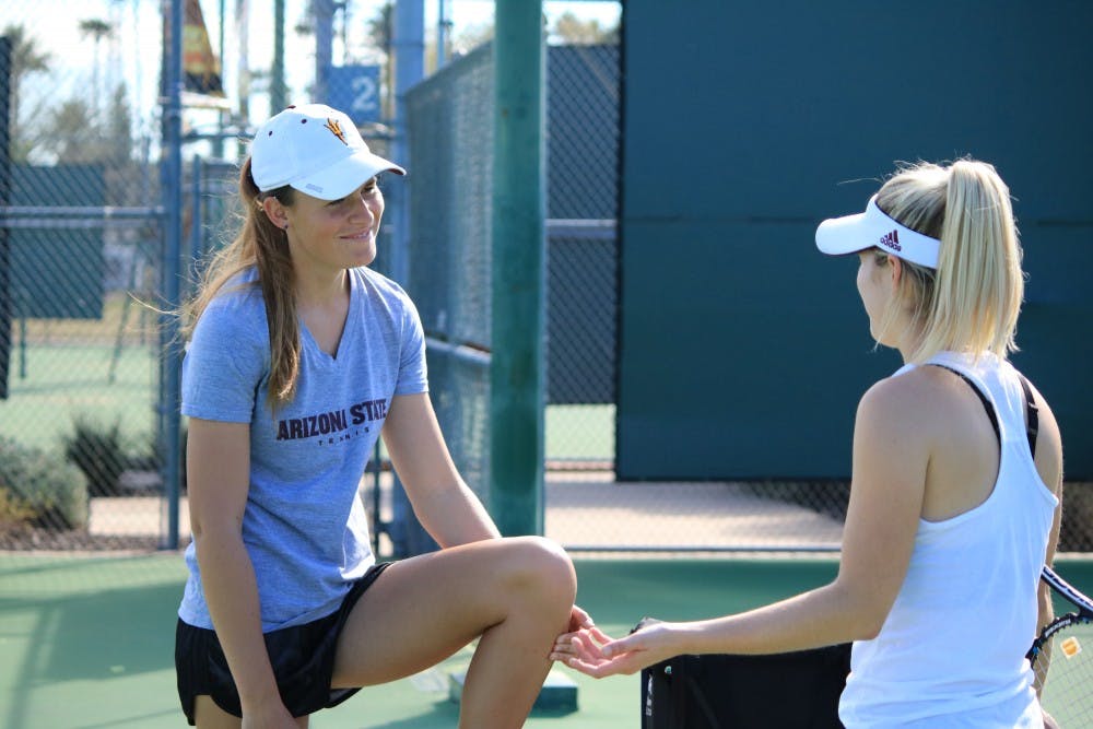 Ebony Panoho, a graduate assistant and ASU women's tennis alum, has a chat with one of the players during the practice at Whiteman tennis center in Tempe, Arizona on Wednesday, Feb. 8th, 2017.