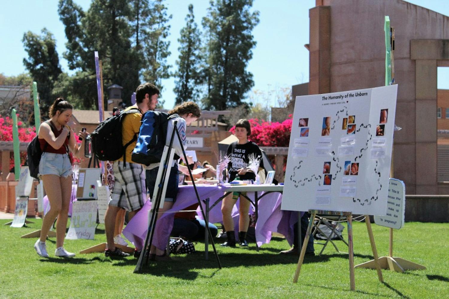 Students gather around a Pregnant on Campus tabling event at Hayden Lawn on Tuesday, March 14, 2017.