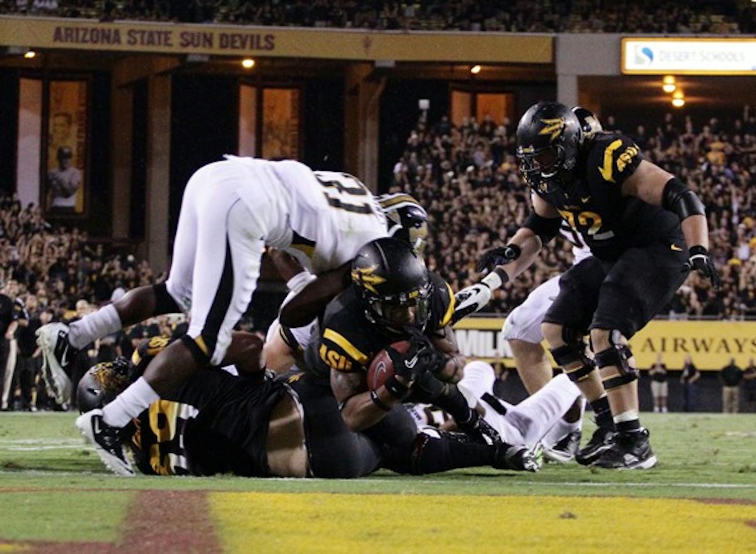 REACHING FOR IT: ASU junior wide reciever Jamal Miles stretches across the goal line for the game-winning touchdown in overtime against Mizzou. (Photo by Beth Easterbrook)