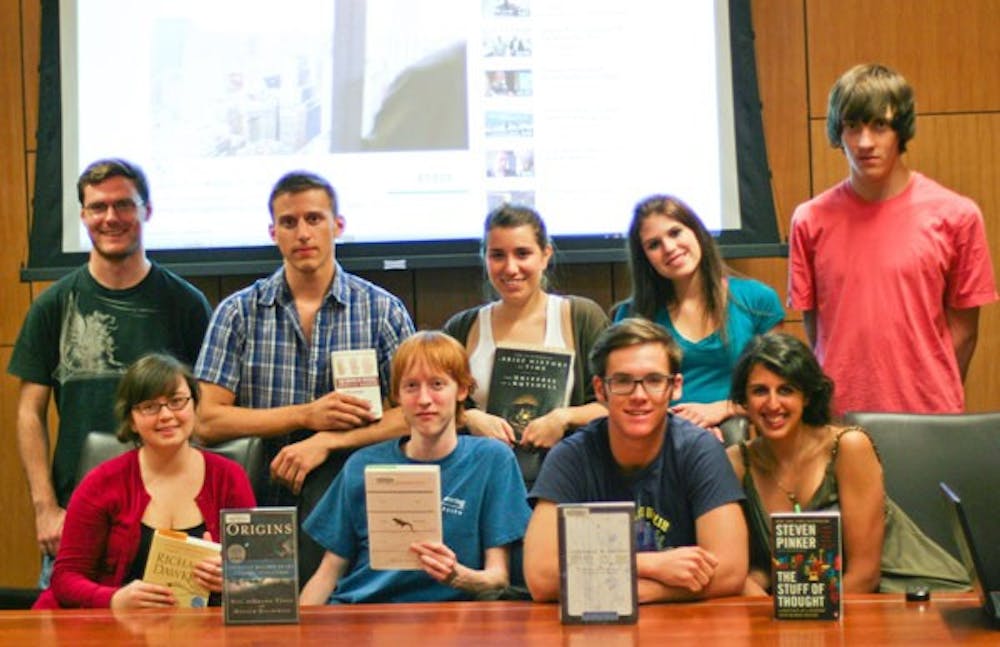 CONTEMPLATING LIFE: The Origins Project Club at ASU holds the various books that they read throughout the semester and over the summer.  After a vote, the group decided to read “Life Ascending” by Nick Lane to discuss at future meetings. (Photo by Lisa Bartoli)