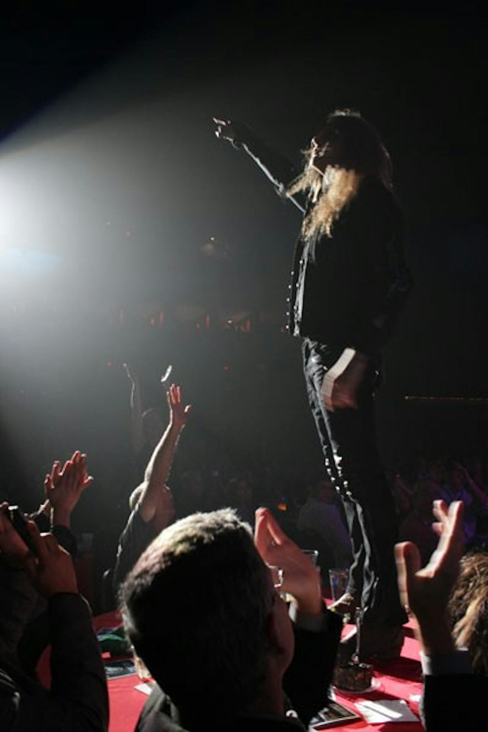 Sebastian Bach leaped off stage Saturday night and onto the table of contributors of Alice Cooper's Solid Rock Foundation.  He gracefully landed in the spotlight. (Photo by Mike Brilliant)