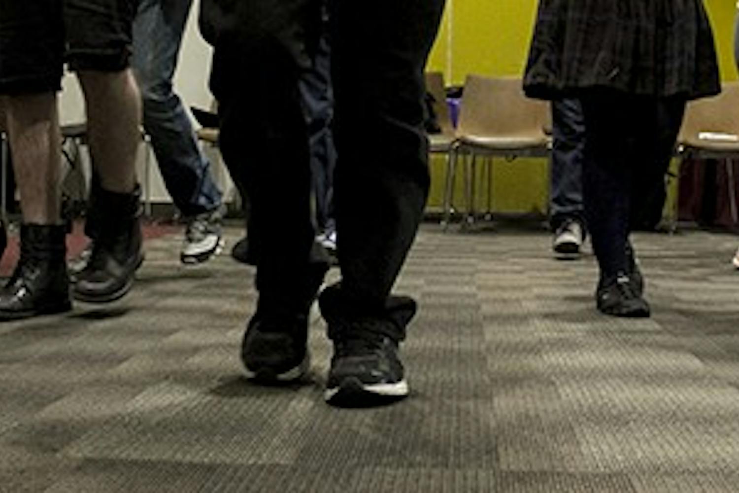 Students played "red light, green light" at DPC Aware's "Hashing Out the Gray" at the Downtown Phoenix Campus on Tuesday, Nov. 4, 2014. Students stepped forward if they agreed with the statement read aloud about relationships. (Photo by Alexis Macklin)