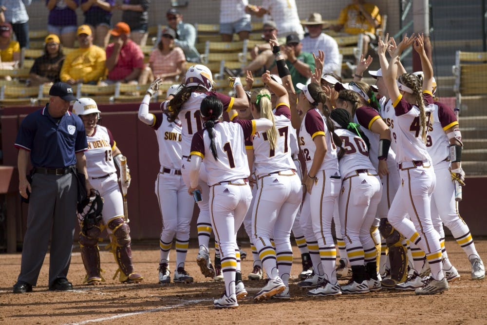 The ASU softball team swarms ASU senior shortstop Chelsea Gonzales (11) at home plate after Gonzales hit a home run during game one of a three game softball series versus the Oregon State Beavers at Alberta B. Farrington Softball Stadium in Tempe, Arizona on Saturday, March 25, 2017. ASU won 8-0.