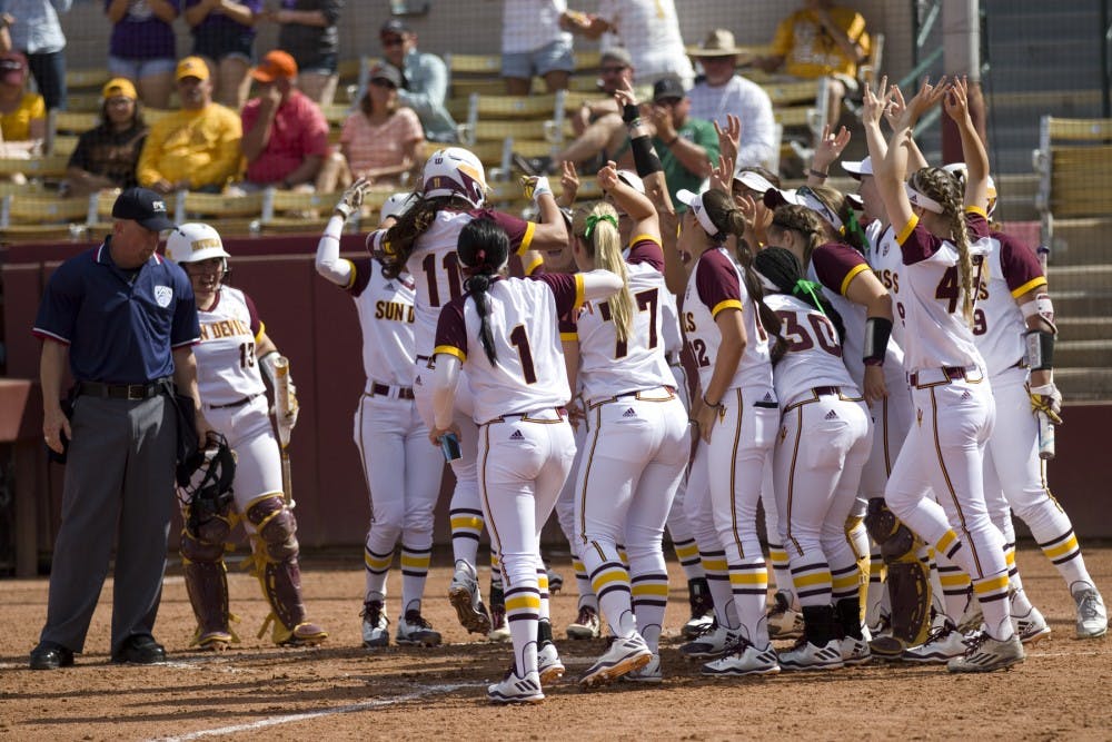 The ASU softball team swarms ASU senior shortstop Chelsea Gonzales (11) at home plate after Gonzales hit a home run during game one of a three game softball series versus the Oregon State Beavers at Alberta B. Farrington Softball Stadium in Tempe, Arizona on Saturday, March 25, 2017. ASU won 8-0.