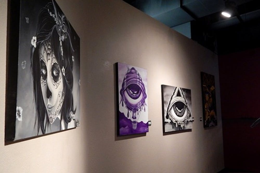 The three pieces (left to right) “Muerta”, “Hot Eyeballon” and “Alien Eye Ship” are by artist Aztec Smurf. (Photo by Olivia Pendergast)